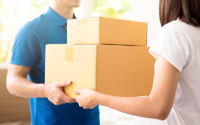 Woman receiving packages from a delivery man